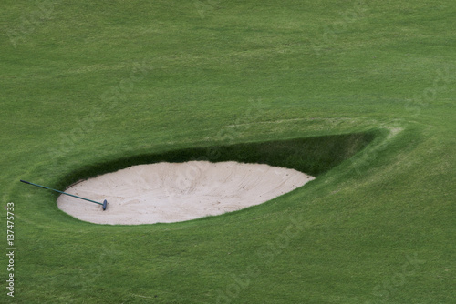 Golf club in a sand trap on a golf course; Maidens, Ayrshire, Scotland photo