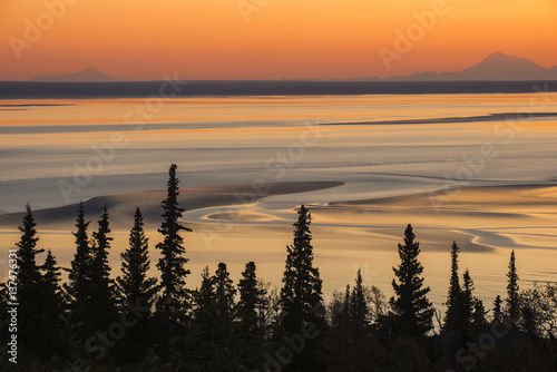 Mudflats at low tide and sunset, with Mt. Iliamna and Mt. Redoubt on the horizon, Turnagain Arm, Southcentral Alaska