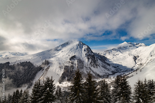 Mountains covered with snow and clouds and trees