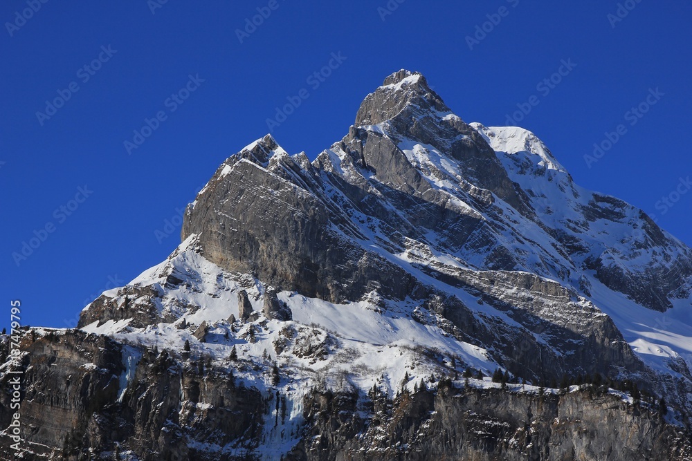 Snow covered peak of mount Ortstock, Swiss Alps.