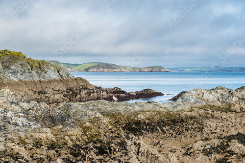 Rock formations leading to an azure blue sea