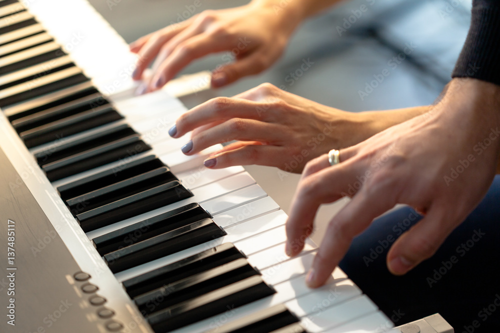 Fototapeta premium Closeup of hands playing piano. Music and hobby concept
