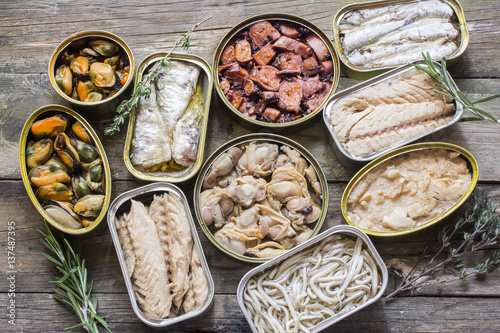 Assortment of cans of canned with different types of fish and seafood photo
