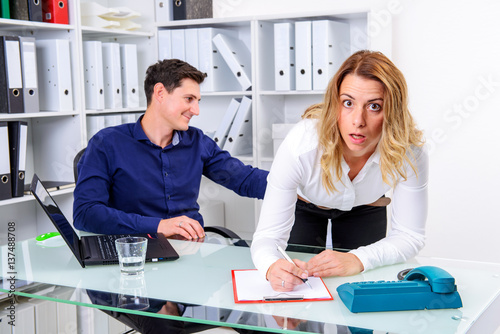 sexual harassment in office- man touch female colleague at butto