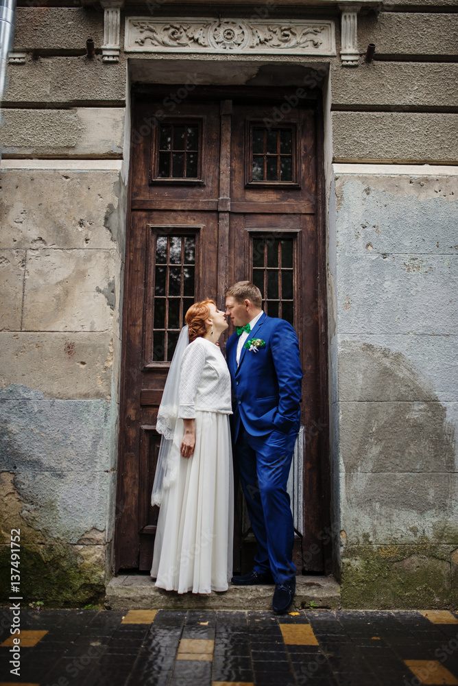 Wedding couple in love background old vintage wooden doors.