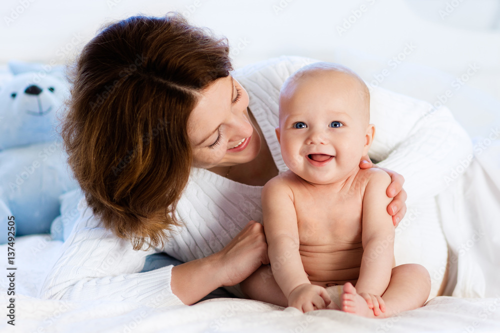 Baby and mother at home in bed. Mom and child. Baby and mother at home in bed. Mom and child.