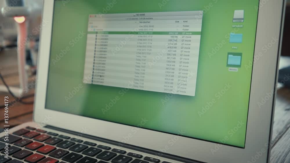 Close up view on portable laptop screen, copy footage files from connected drone into movies folder Close up view on portable laptop screen, copy footage files from connected drone into movies folder