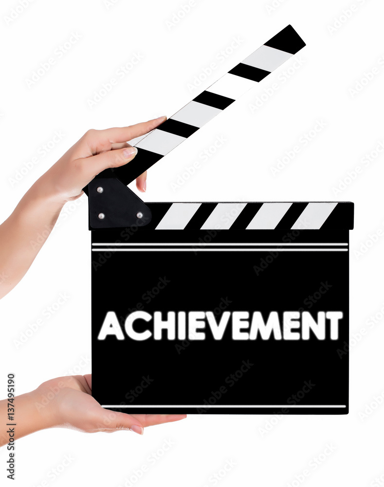 Hands holding a clapper board with Archievement text