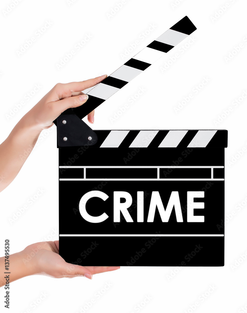 Hands holding a clapper board with CRIME text