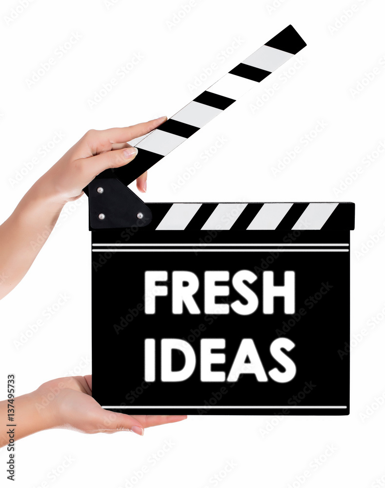 Hands holding a clapper board with FRESH IDEAS text