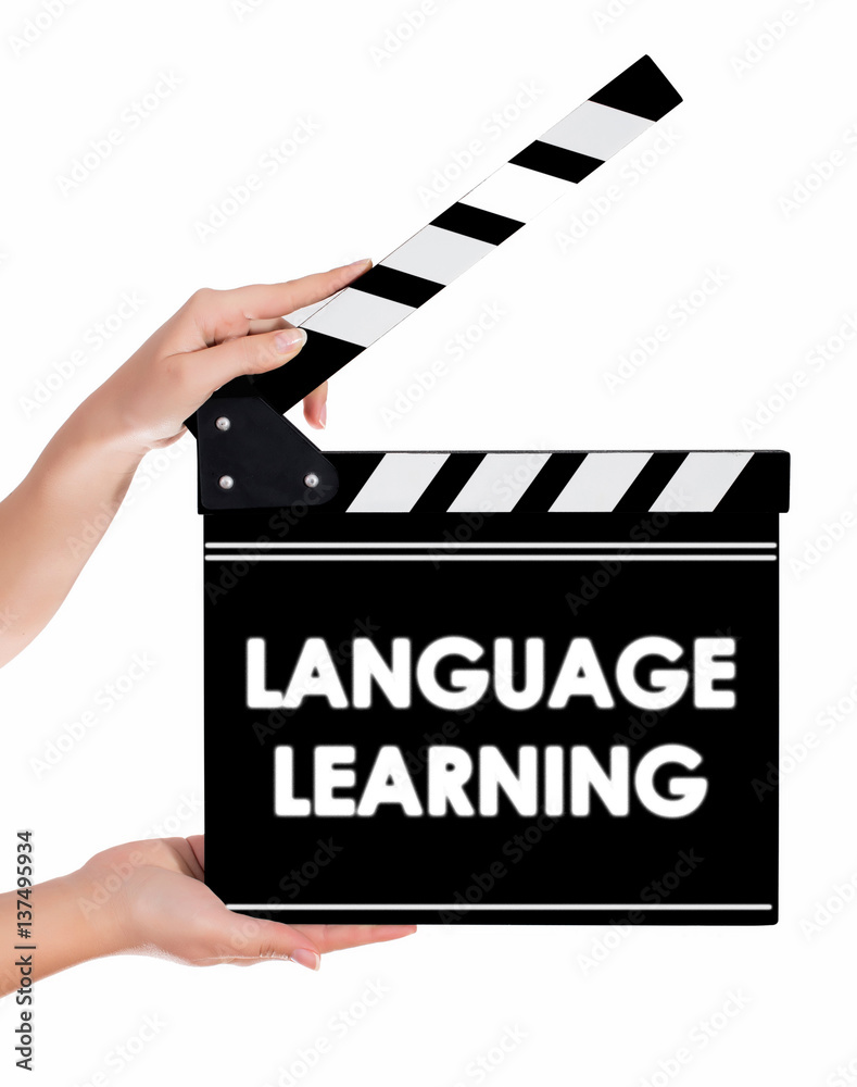 Hands holding a clapper board with LANGUAGE LEARNING text