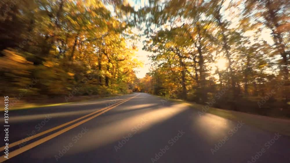 Autumn POV driving shot of the Blue Ridge Parkway through North Carolina at sunset