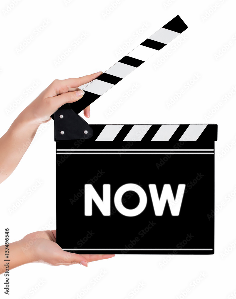 Hands holding a clapper board with NOW text