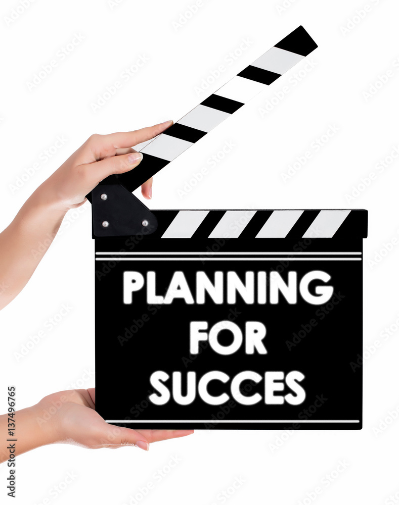 Hands holding a clapper board with PLANNING FOR SUCCESS text