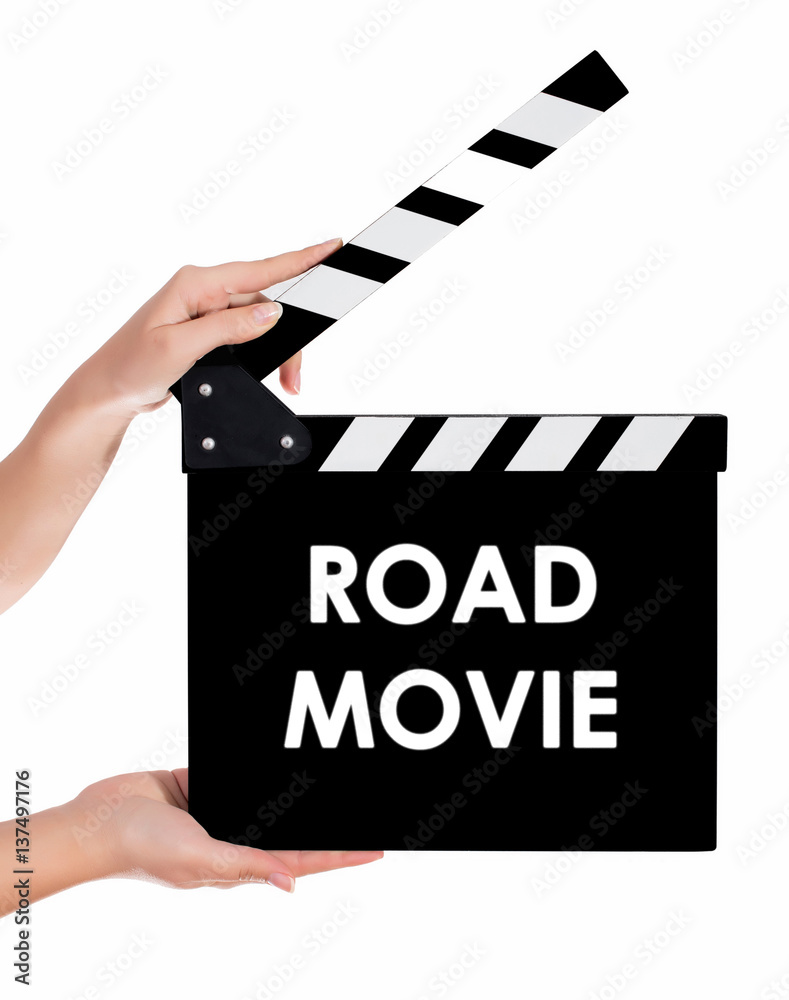 Hands holding a clapper board with ROAD MOVIE text