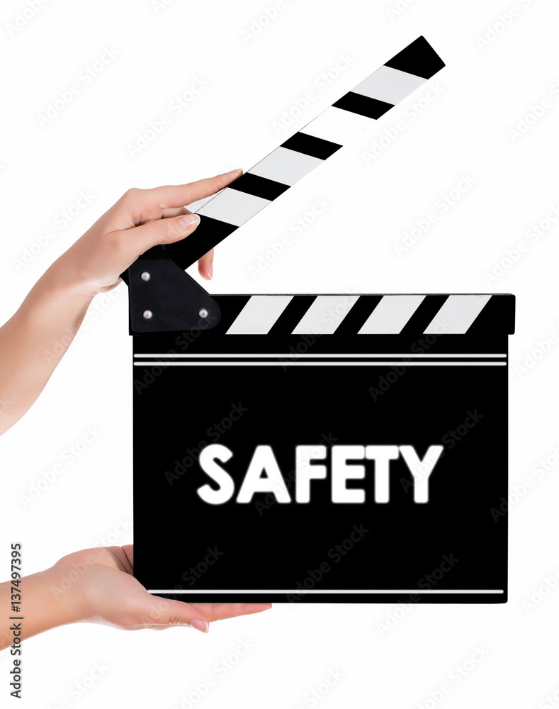 Hands holding a clapper board with SAFETY text