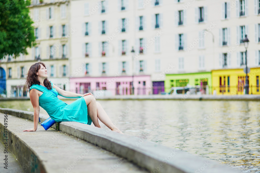 Cheerful young French woman having fun on Saint-Martin canal Cheerful young French woman having fun on Saint-Martin canal