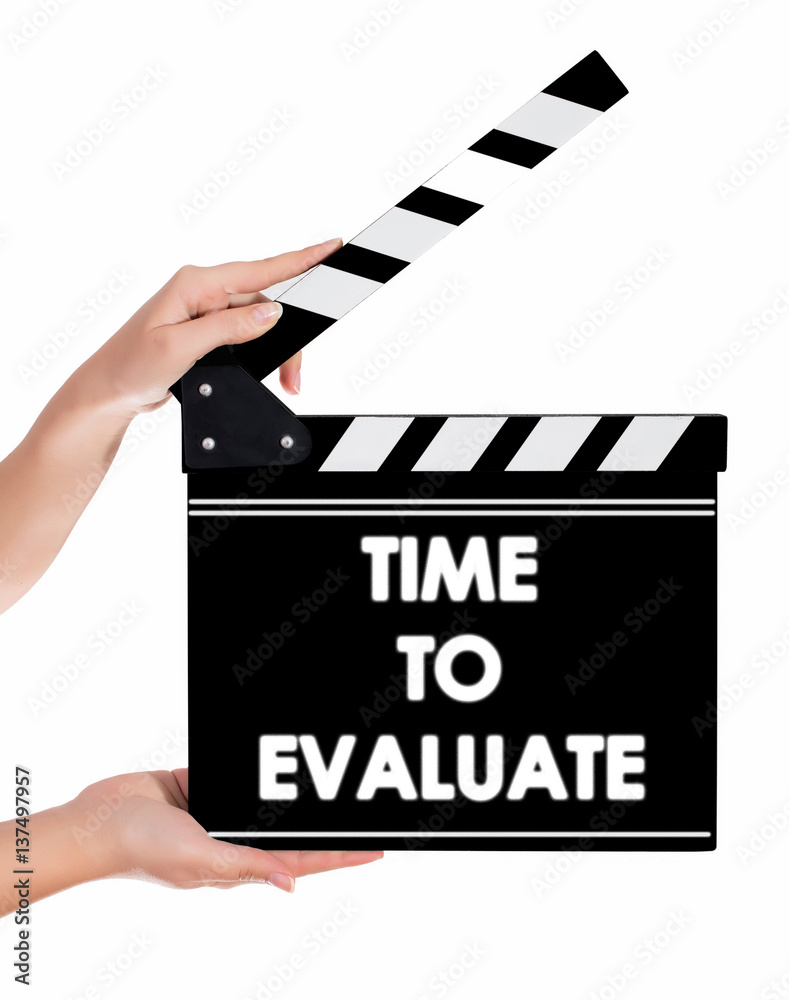 Hands holding a clapper board with TIME TO EVALUATE text