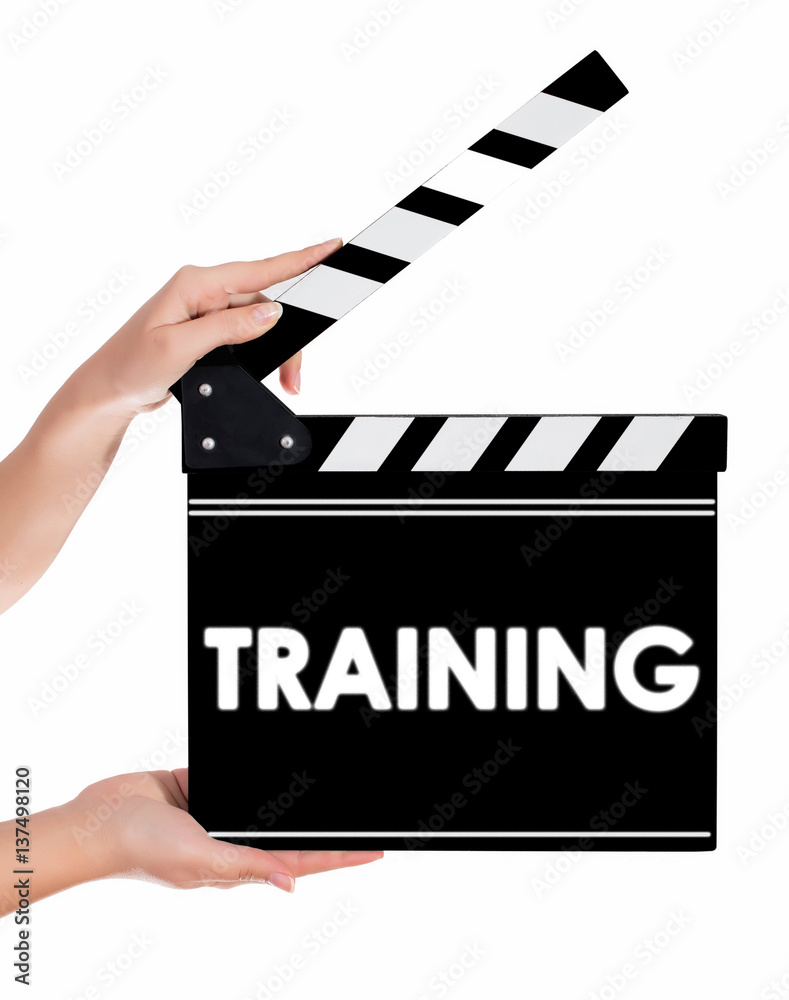 Hands holding a clapper board with TRAINING text