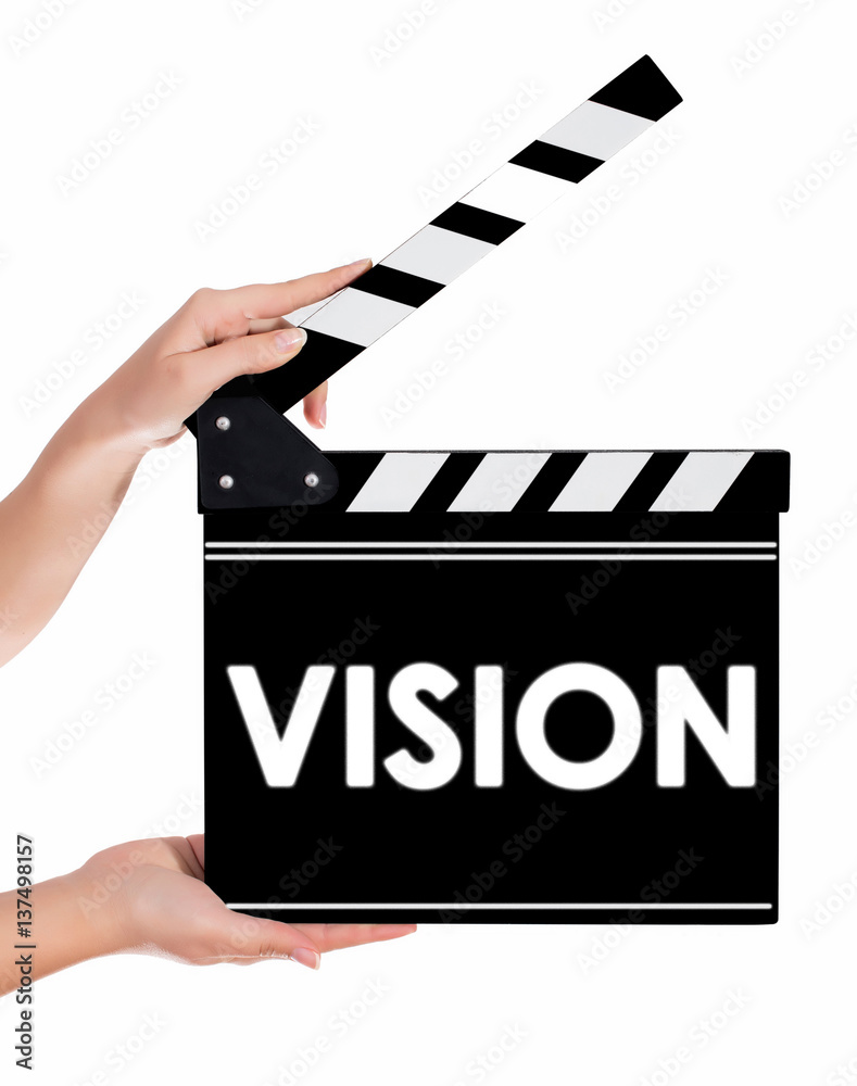 Hands holding a clapper board with VISION text