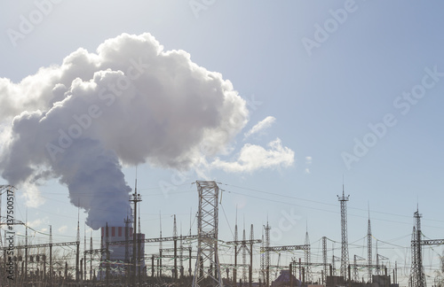 Thick white smoke from the chimney of a nuclear power plant. High-voltage © DedMityay