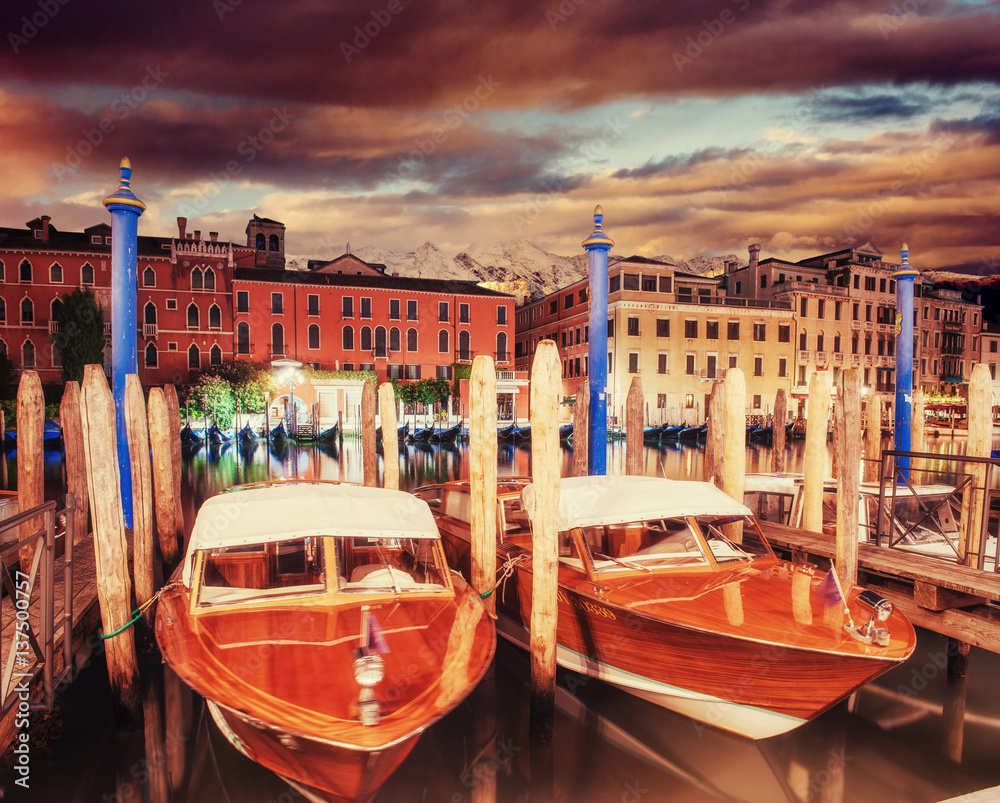 City landscape. Venice at sunset. Green water with boats