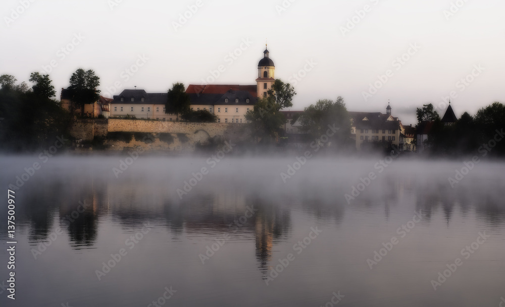 Castle above the lake in a fog