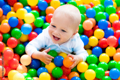 Child playing in ball pit on indoor playground