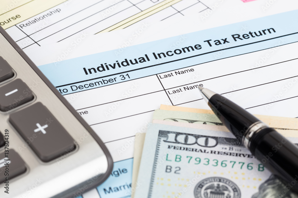 Tax form with calculator, pen, and dollar banknote; document are mock-up Tax form with calculator, pen, and dollar banknote; document are mock-up