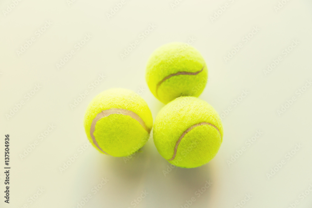 close up of three yellow tennis balls