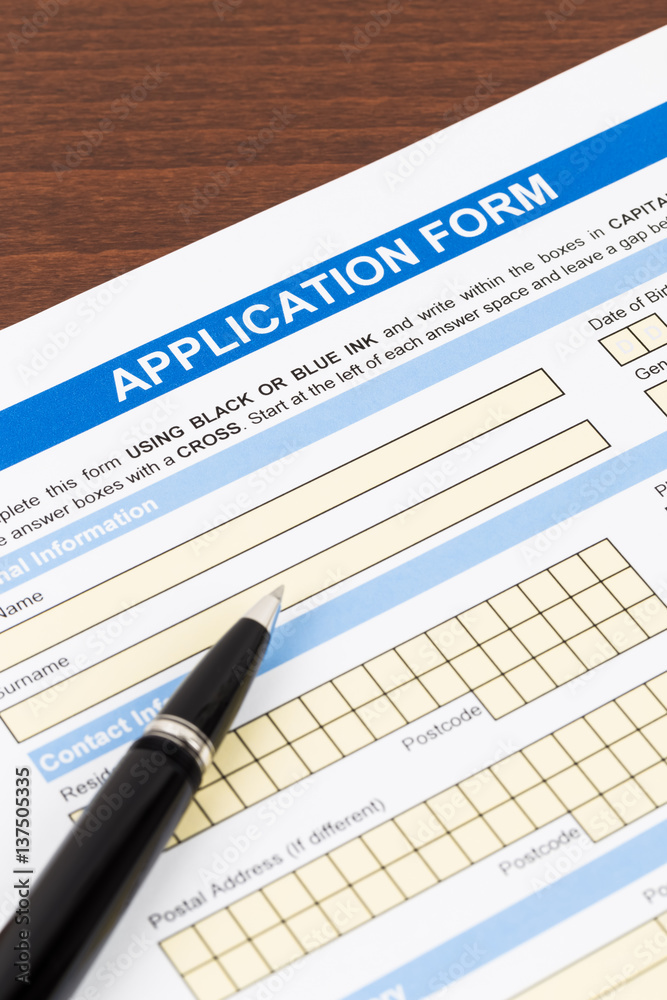 Application form with pen; document is mock-up Application form with pen; document is mock-up