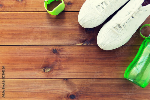 close up of sneakers, bracelet and water bottle