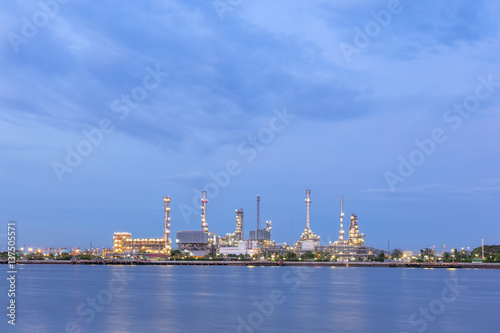 Oil refinery on water front at twilight