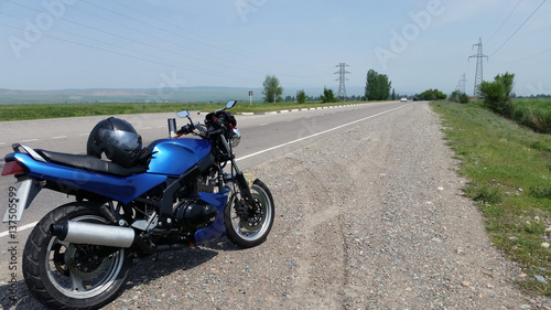 Fototapeta Naklejka Na Ścianę i Meble -  Blue motorbike on the road