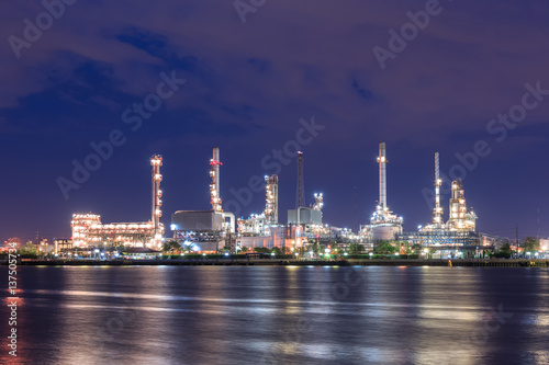 Oil refinery on water front at night