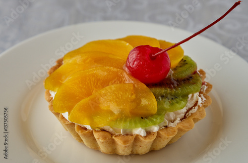 Tartlets with cream and fruit. Cherry  peach and kiwi.