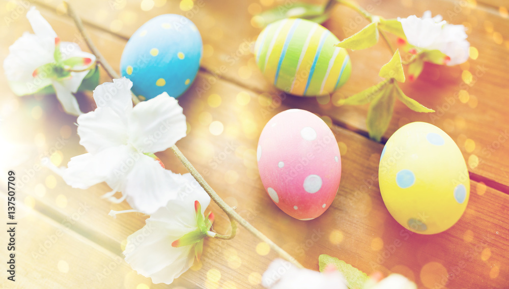 close up of colored easter eggs and flowers