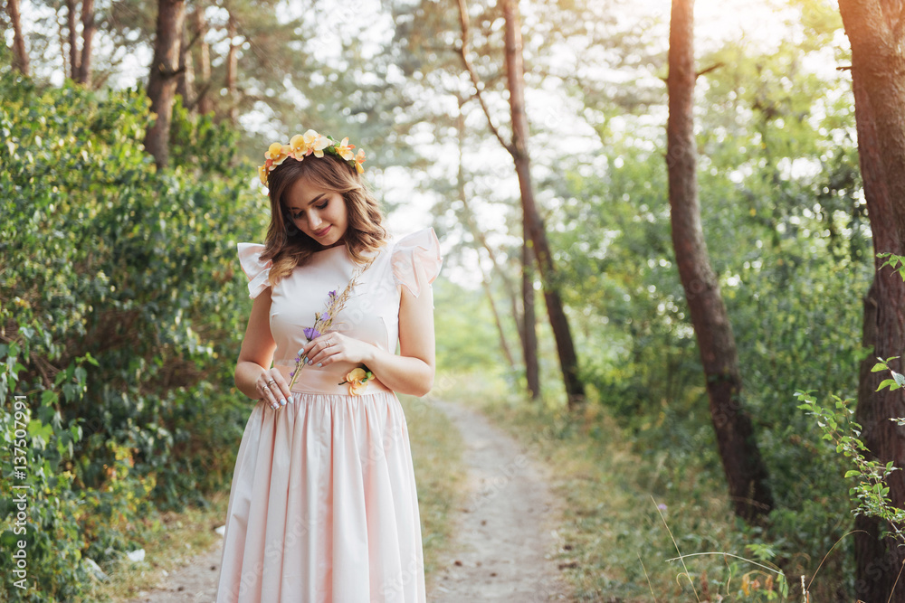 Happy young woman in long dress a beautiful pine forest Happy young woman in long dress a beautiful pine forest