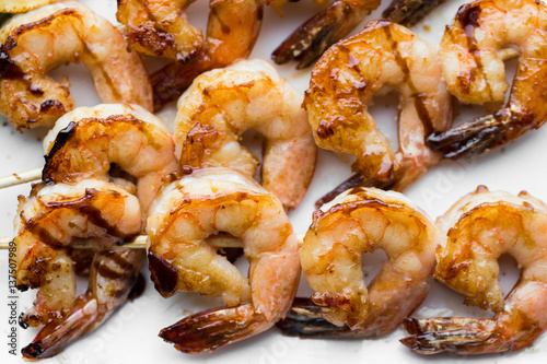 tasty spiced shrimp skewers on a barbecue