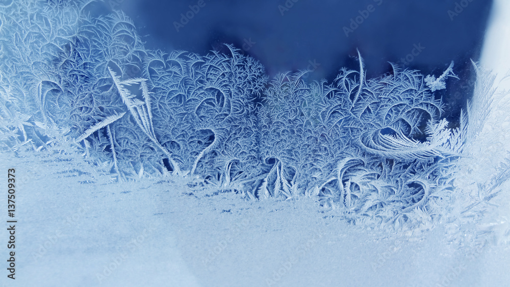 Ice flowers frozen window background. macro view photography frost textured pattern. cold winter weather xmas concept. shallow depth field