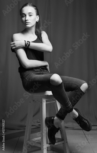 Sexy female model posing in fashion dress, black and white photo, colorless.