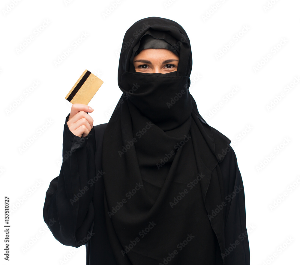 muslim woman in hijab with credit card over white