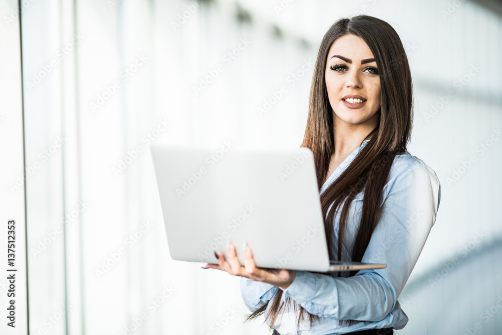business woman with laptop in office with panoramic windows. business woman with laptop in office with panoramic windows.