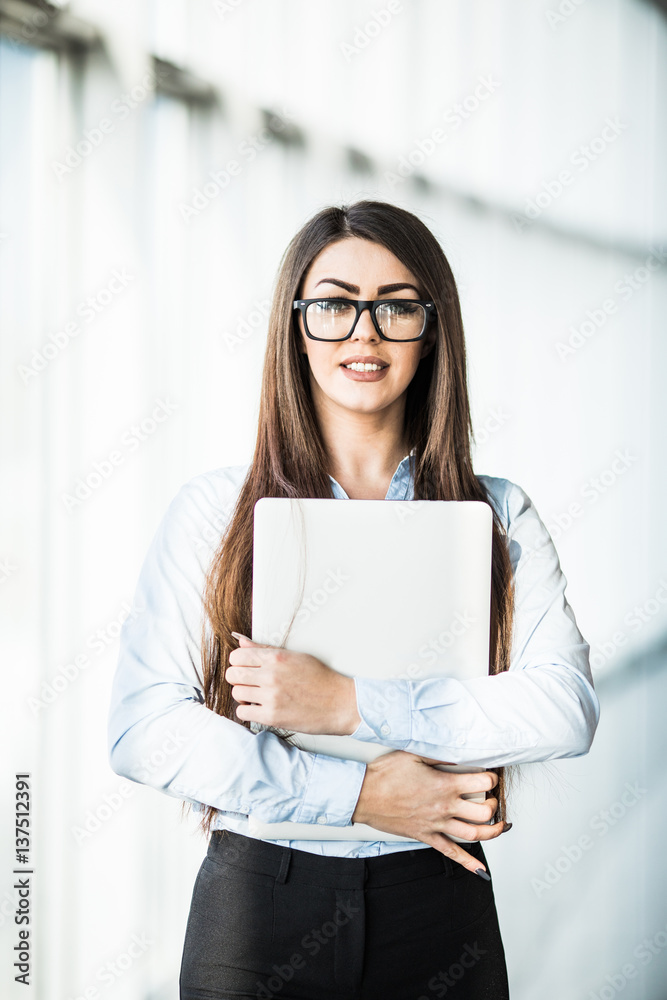 business woman with laptop in modern office. business woman with laptop in modern office.