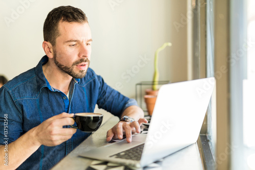 Busy man working and drinking coffee