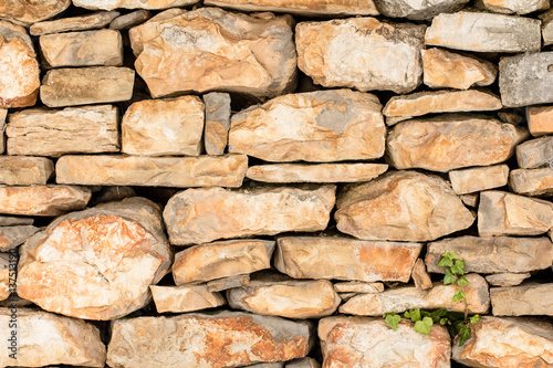 Old vintage hand made rock stone wall texture pattern background