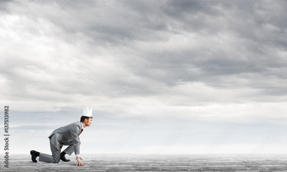 King businessman in elegant suit running and blue sky at background King businessman in elegant suit running and blue sky at background