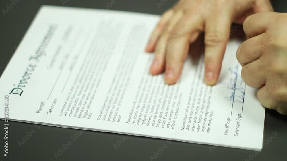 Man Signs Divorce Agreement Shallow DOF Man Signs Divorce Agreement Shallow DOF