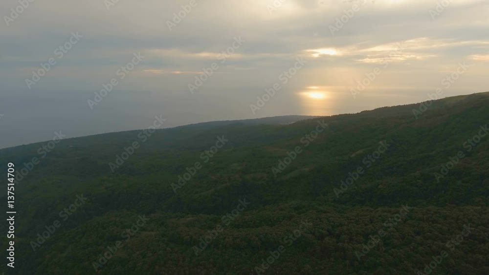 Sunset on tropical island, ocean, mountains. Aerial view coastline on tropical island with sea, trees and palms. Aerial footage.Aerial video from flying drone of amazingly beautiful landscape of Sunset on tropical island, ocean, mountains. Aerial view coastline on tropical island with sea, trees and palms. Aerial footage.Aerial video from flying drone of amazingly beautiful landscape of