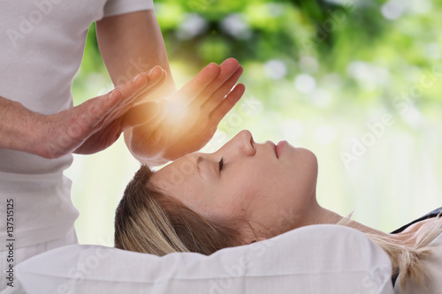 Fotografie, Obraz Woman having reiki healing treatment , alternative medicine concept
